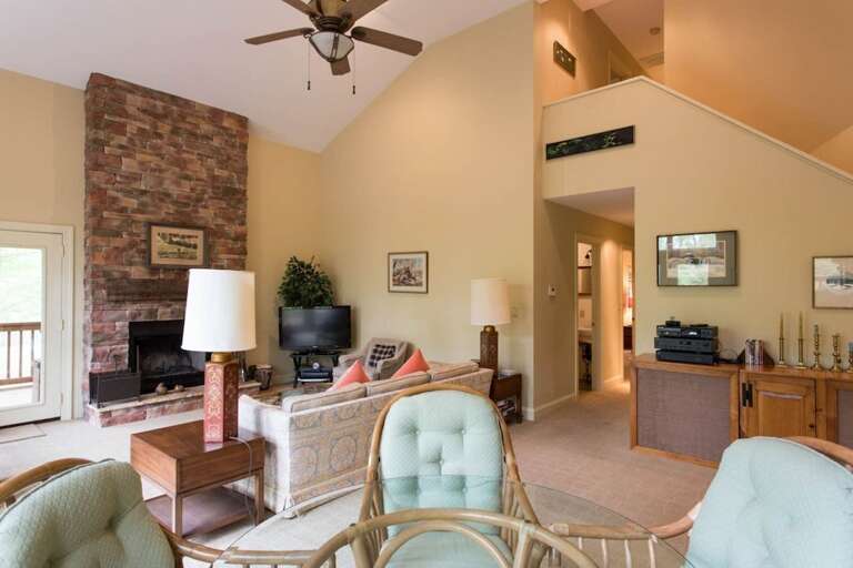 A hall leads to a half bath and then a queen bed suite.