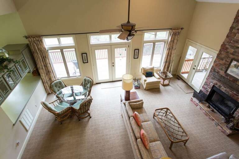 Here is the view of the living and dining areas from the stairs. The windows and French doors are striking. Here is the view of the living and dining areas from the stairs. The windows and French doors are striking.