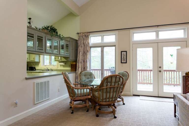 Just past the kitchen is the dining area with a table that seats 4. Just past the kitchen is the dining area with a table that seats 4.