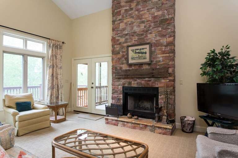 The focal point of the living area is the beautiful fireplace with stones that rise to the ceiling. The focal point of the living area is the beautiful fireplace with stones that rise to the ceiling.