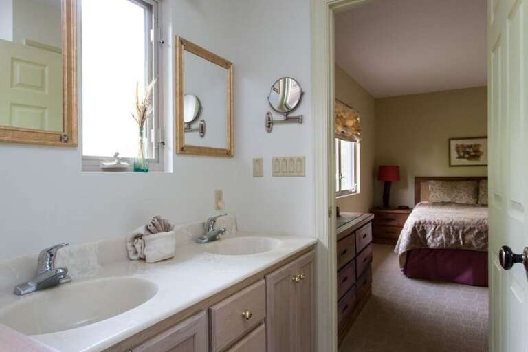 A window about the vanity, between the sinks, lets in plenty of natural light. A window about the vanity, between the sinks, lets in plenty of natural light.