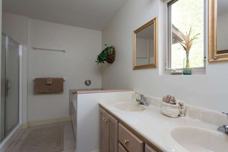 The private adjoining bath has a double vanity, walk-in shower, and jetted tub. The private adjoining bath has a double vanity, walk-in shower, and jetted tub.