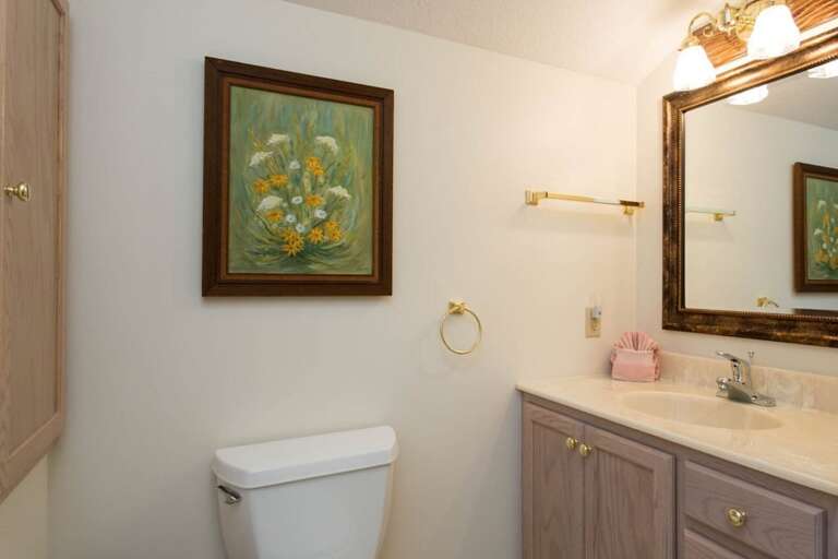 The second level bathroom has a single vanity.