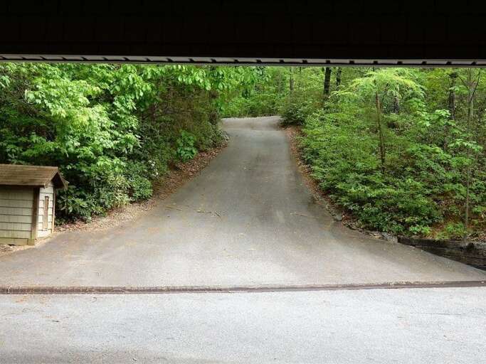 A long, paved drive leads to the home that is nestled among the trees. A long, paved drive leads to the home that is nestled among the trees.