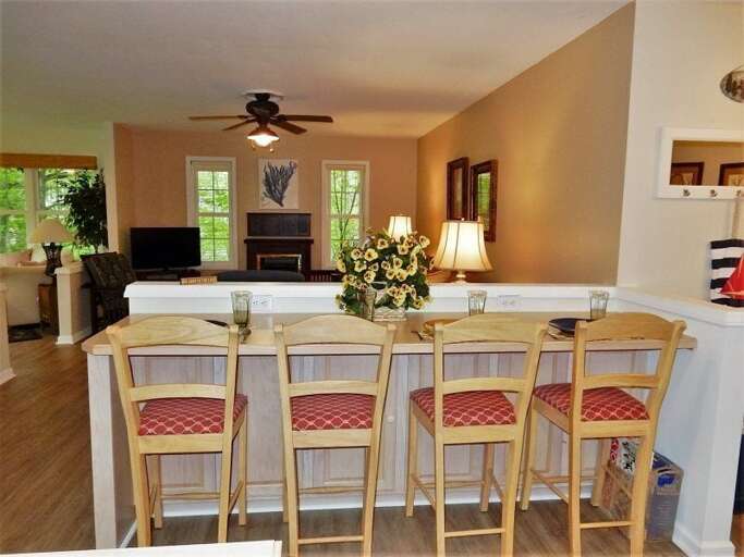 Additional seating for 4 across from the kitchen overlooks the living area. Additional seating for 4 across from the kitchen overlooks the living area.