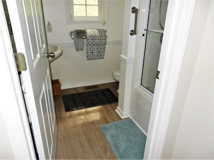 At the end of the hall is a full bath. At the end of the hall is a full bath.