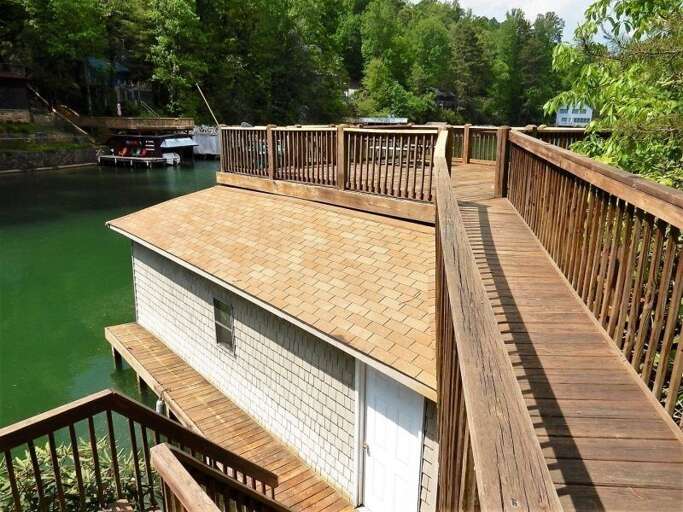 The home has a spacious boat house complete with dock and topside deck. The home has a spacious boat house complete with dock and topside deck.