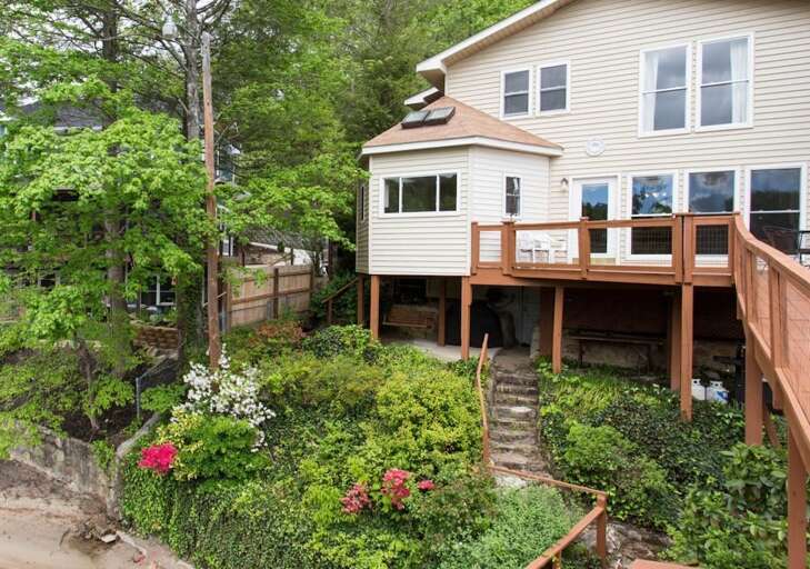 Notice the patio, below the house structure, with a swing and gas grill. Notice the patio, below the house structure, with a swing and gas grill.