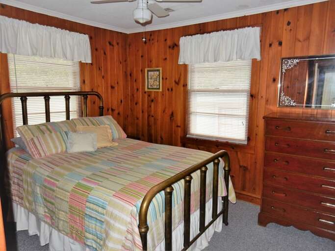 On the upper or street level of the home are 4 bedrooms. This first bedroom has a full bed. On the upper or street level of the home are 4 bedrooms. This first bedroom has a full bed.