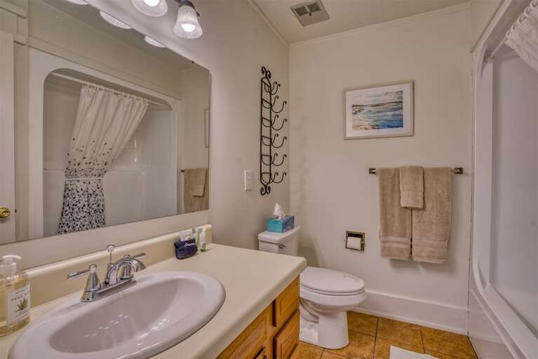 Upstairs Full bathroom with shower and tub, toilet and sink with plenty of counter space