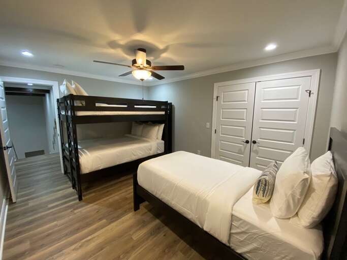Upper level bedroom with twin bed and bunk beds