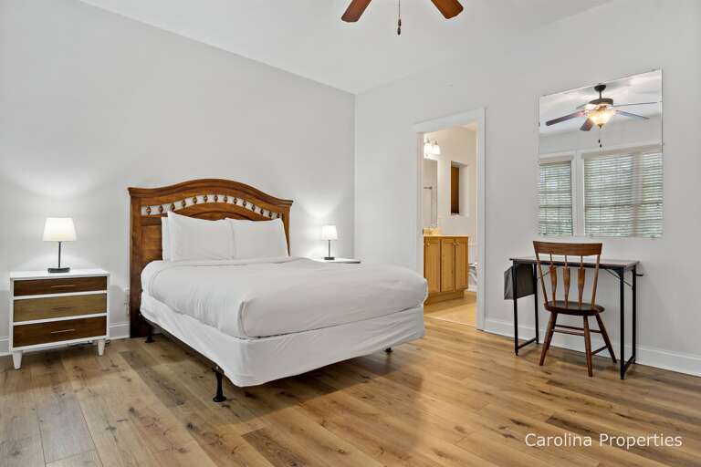 Additional view of lower level private bedroom with a desk