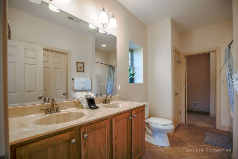 Lower level full bathroom accessible from private sleeping room and hall additional view