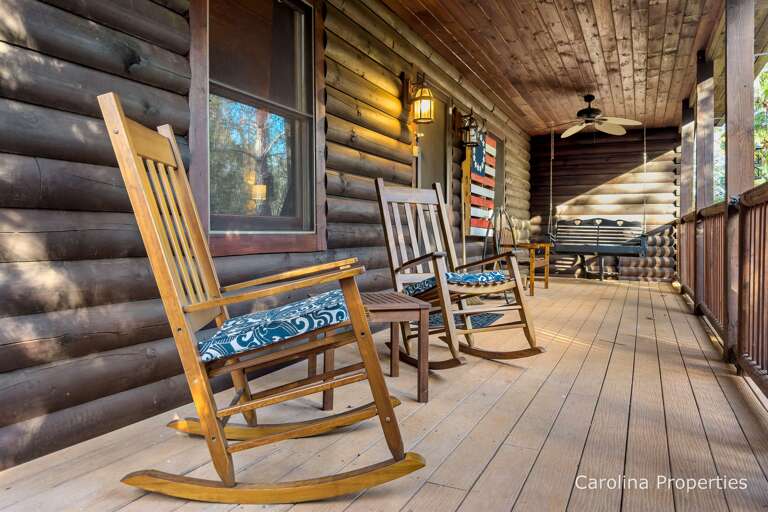 Beautiful front porch with rocking chairs and porch swing