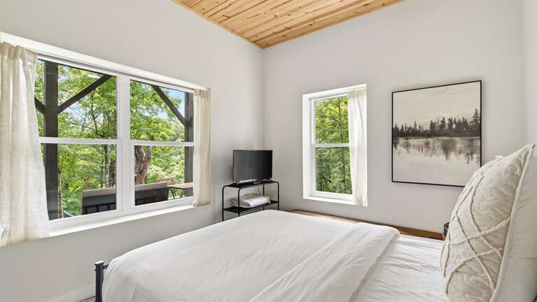 Bedroom 2 features a queen size bed and  a tv