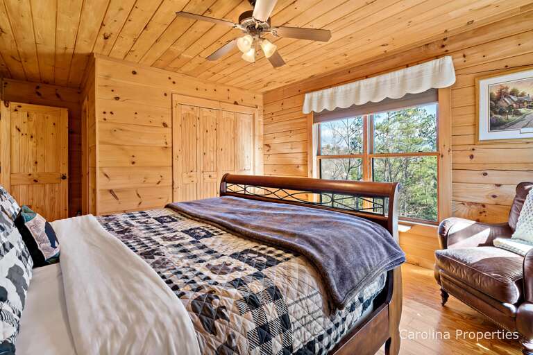 Main Level Primary Suite features King size bed and comfy chair