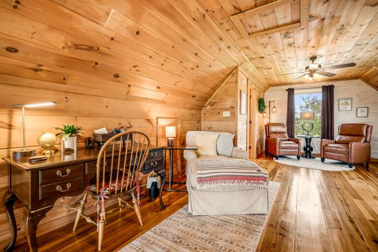 Loft area with a desk and additional seating