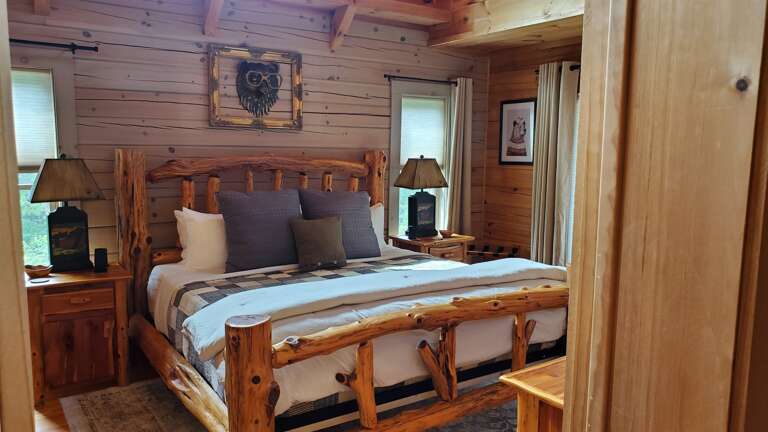 Main level master bedroom with a king size bed. Main level master bedroom with a king size bed.