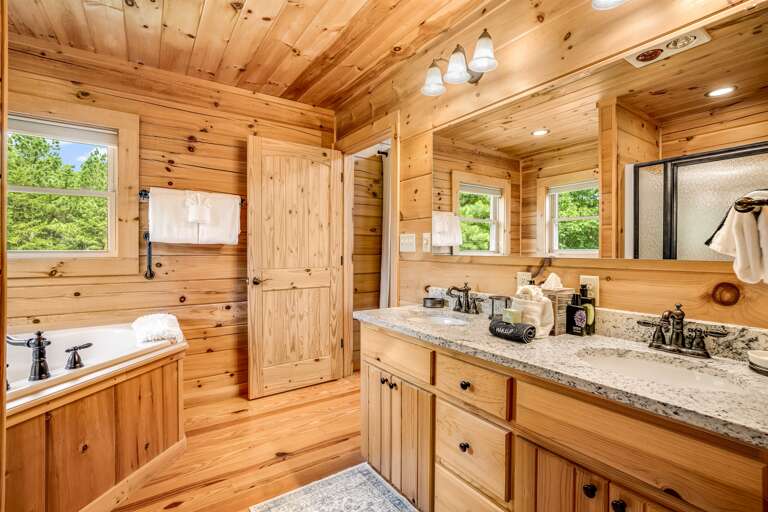 Additional view of master bathroom, featuring a large bath tub