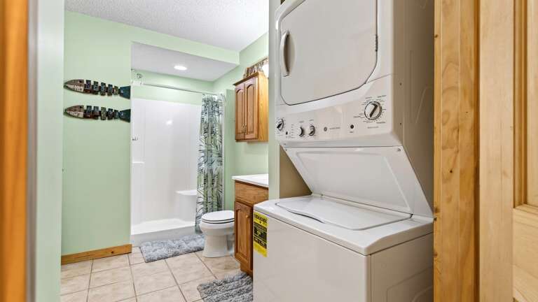 Jack and Jill bathroom with walk in shower and washer and dryer