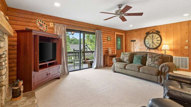 Sliding glass doors lead to the large, wrap around deck