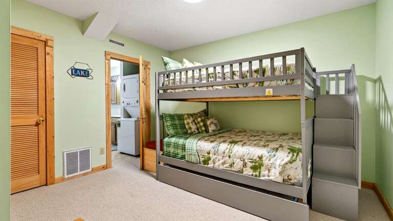 Lower level bedroom with queen bunk beds