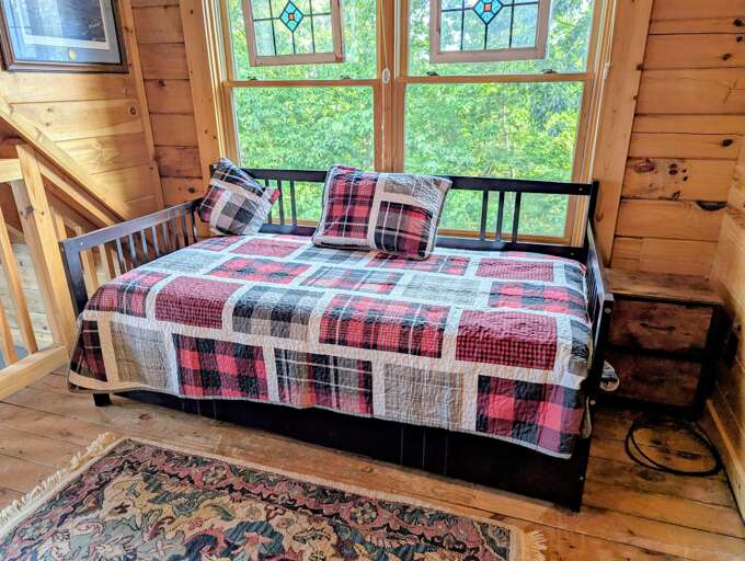 Twin bed with trundle located in the loft. 