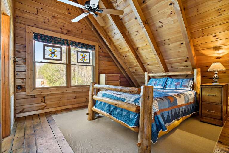 Queen bed in the upper level bedroom