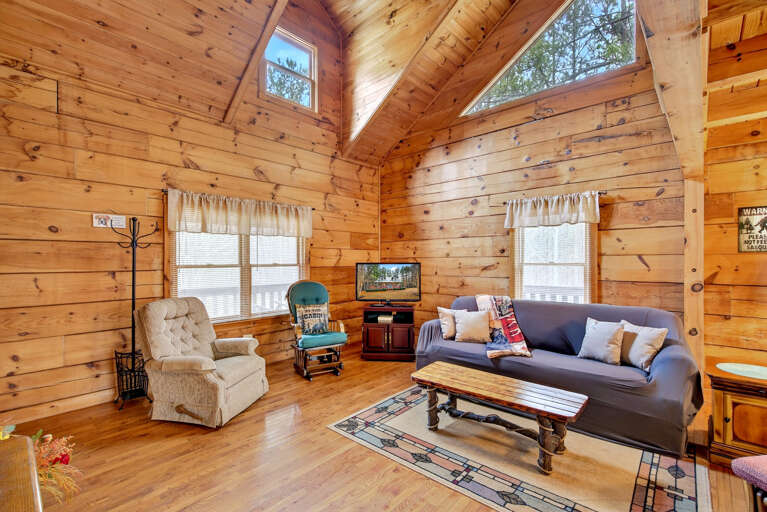 There is a TV in the living room with a Roku