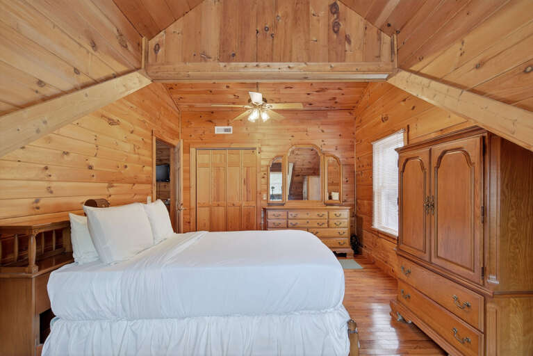 Upstairs bedroom with queen sized bed and large wardrobe