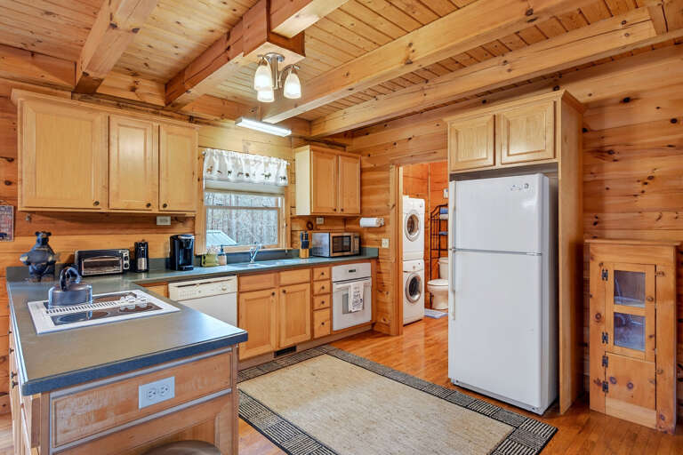 The kitchen includes a refrigerator with working ice maker, dishwasher and microwave 
