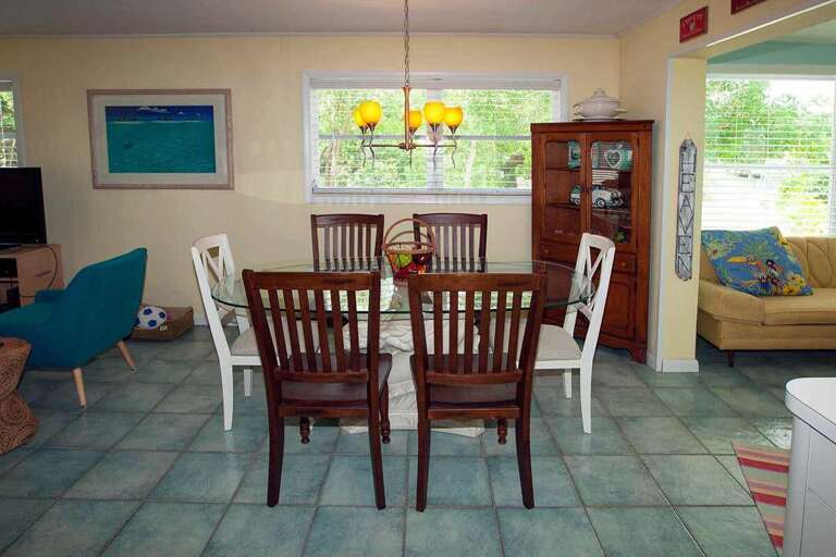 Interior Of Vacation Rental Living Space With Dining Table And Sofa