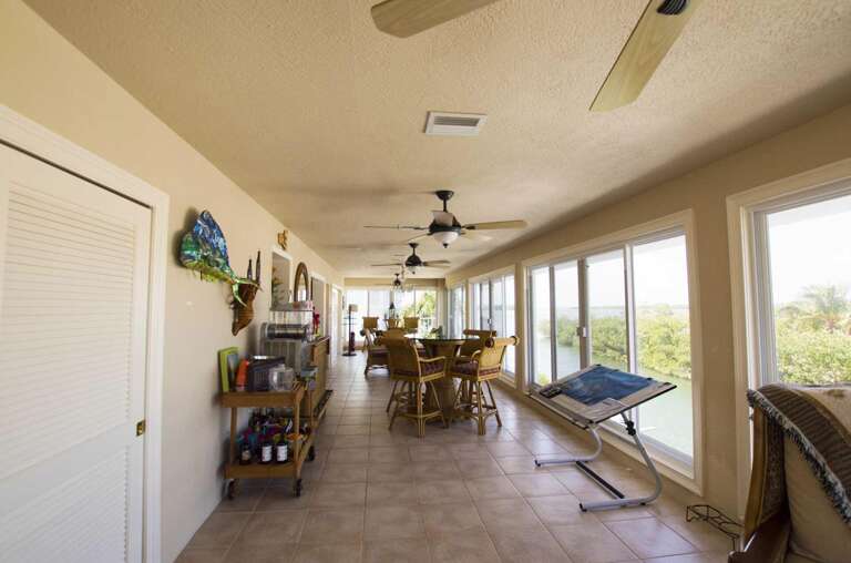 Spacious Interior Of A Vacation Rental With Dining Area And Ceiling Fans
