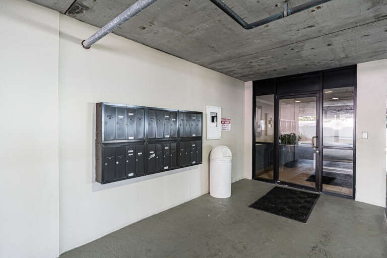 Modern building entrance with mailboxes and glass doors for easy access.