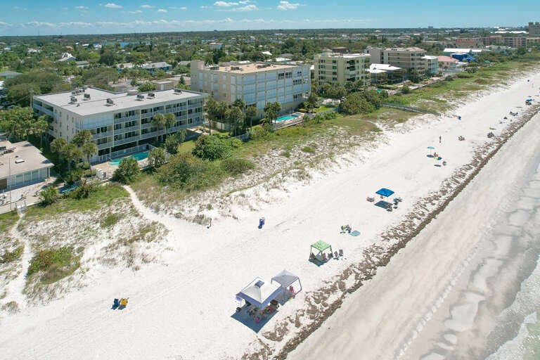 Beachfront properties stretch along pristine white sand, offering direct access to the Gulf Coast's sparkling waters and natural dunes.