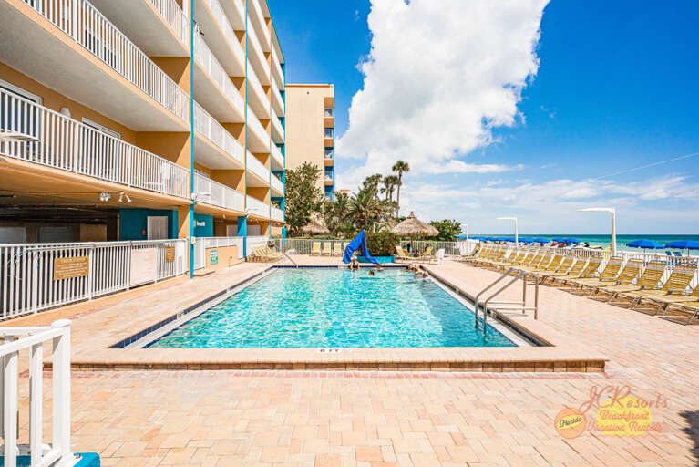 Dive into your own slice of paradise with this sparkling pool overlooking the beach, where sunny days and ocean breezes await.