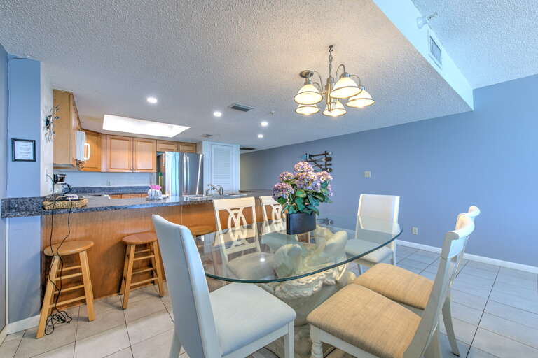 Gather around your spacious dining table for memorable meals, with the fully-equipped kitchen just steps away for easy entertaining.