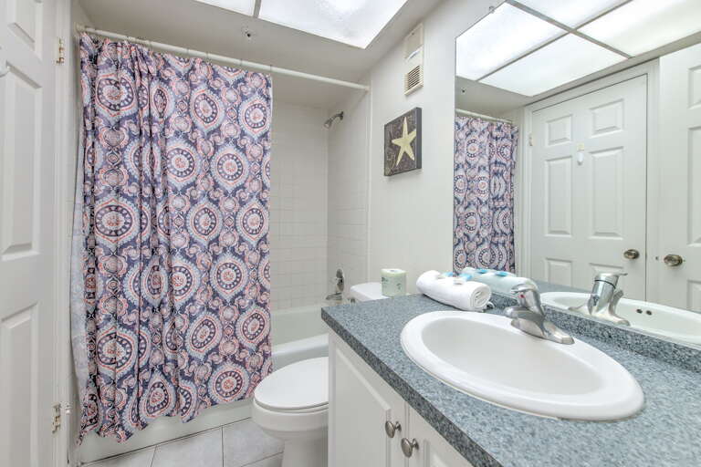 Your private bathroom features fresh towels, natural skylight, and all essentials for a refreshing start to each day.