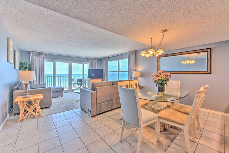 Relax in your bright oceanfront living space where floor-to-ceiling windows frame stunning sea views, perfect for morning coffee or evening dinners.
