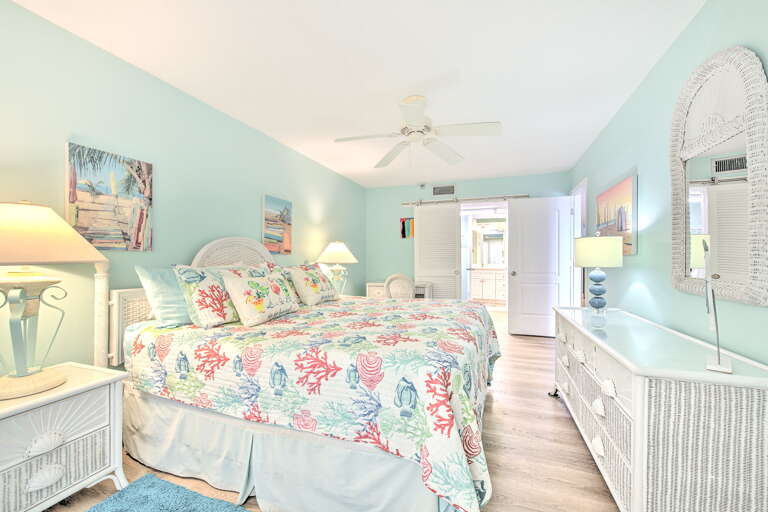 Drift off to sleep in this tranquil coastal bedroom, where sea-inspired linens and soft turquoise walls create your perfect oceanside retreat.