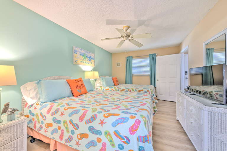 Step into your bright coastal bedroom featuring cheerful flip-flop linens and tropical colors that instantly make you smile.