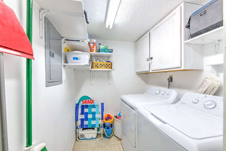 Your dedicated laundry room keeps you organized with a washer, dryer, and plenty of storage for beach gear and supplies.