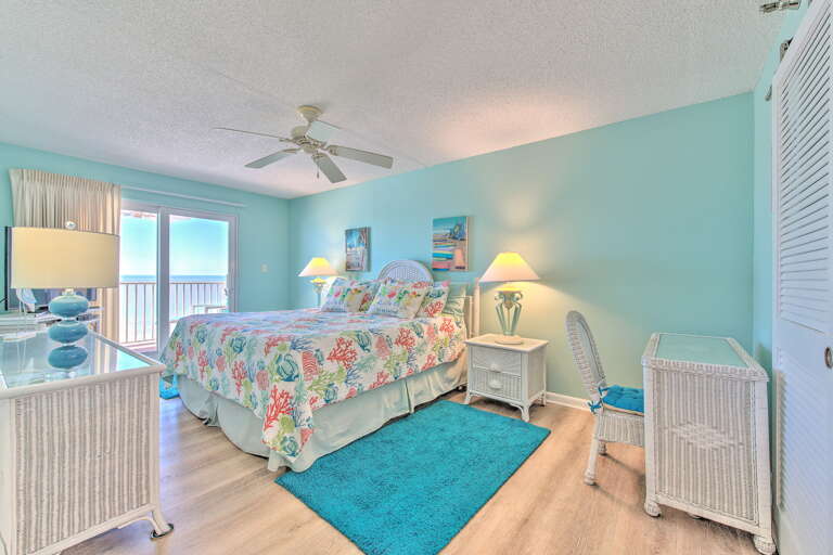 Wake to ocean breezes in your serene bedroom, where tropical dÃ©cor and a private balcony create the perfect coastal retreat.