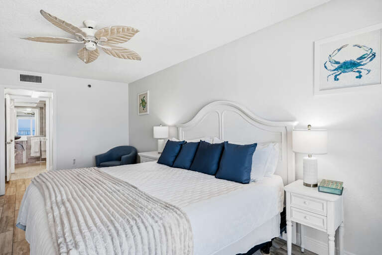 Drift off in this serene coastal bedroom where crisp white linens and navy accents create your perfect seaside retreat.