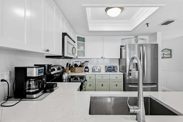 Your fully equipped kitchen awaits with stainless steel appliances, coffee maker, and everything needed to create memorable meals during your stay.
