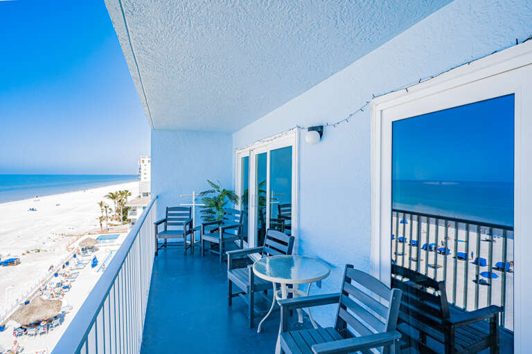 Your private beachfront balcony offers stunning ocean views and comfortable seating for morning coffee or sunset cocktails with endless beach vistas.