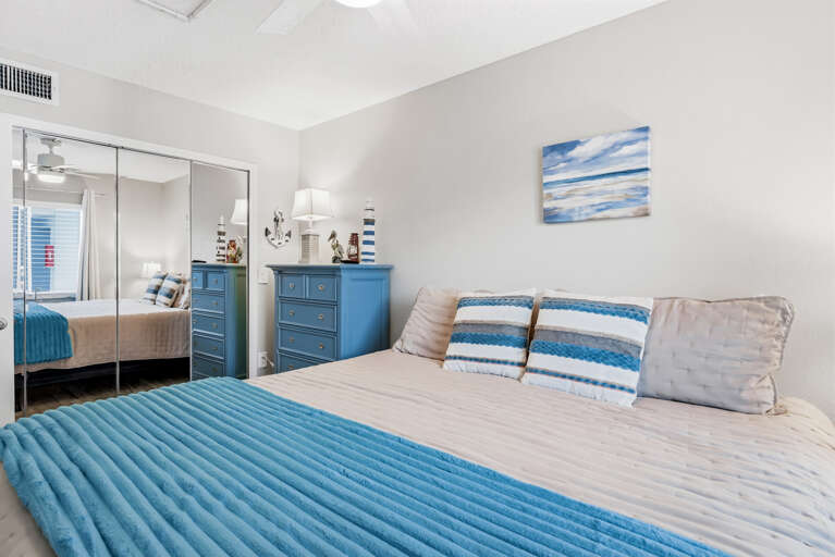 Relax in your coastal-themed bedroom featuring ocean-blue accents and plush bedding that invites peaceful sleep.