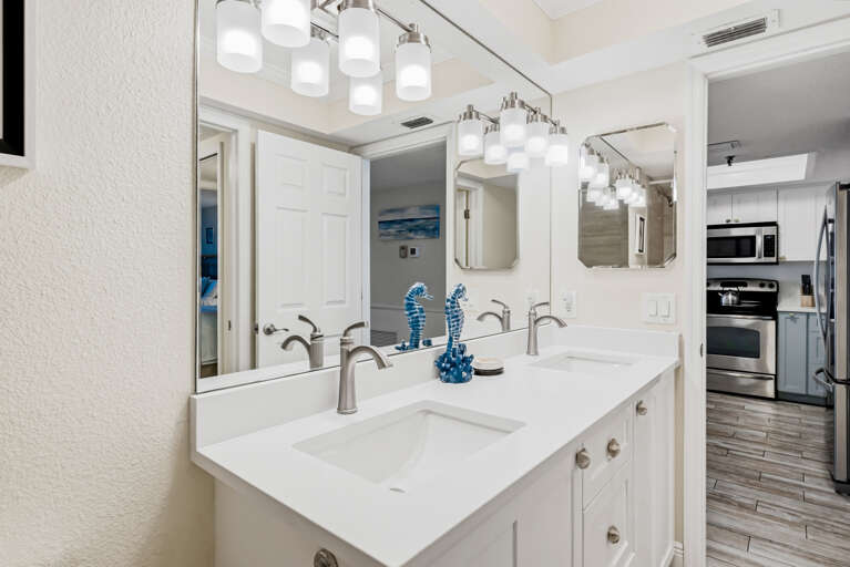 Beautiful dual-sink vanity with elegant lighting where you can start your mornings refreshed in this thoughtfully designed space.