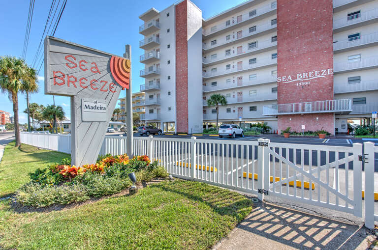 Welcome to Sea Breeze, a bright beachfront property located on Madeira Beach with convenient gated access and tropical landscaping.