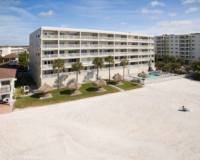 Beachfront property featuring white sand access, swimming pool, and multiple balconied accommodations in a prime coastal location.